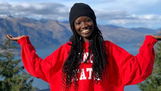 Illinois State Student posing in front of mountains in New Zealand.