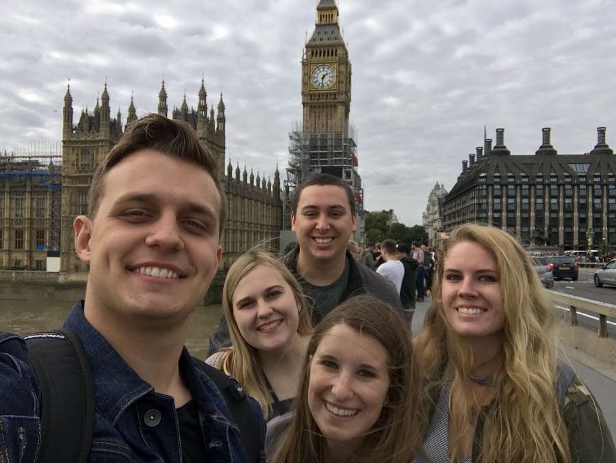 group of students stand in front of big ben